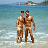 Guys sunbathe beach nude.
